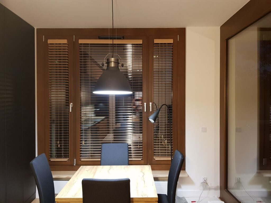 żaluzje drewniane 50 mm, montaż do  ramy okiennej, kolor brązowy z maskownicą górną kolor beżowy